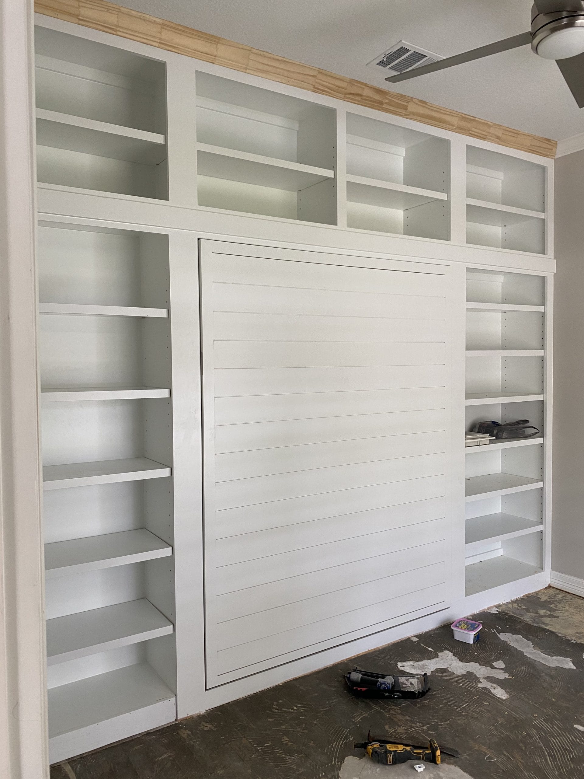 The Hidden Retreat finished shelving and closed Murphy bed, full project view 4
