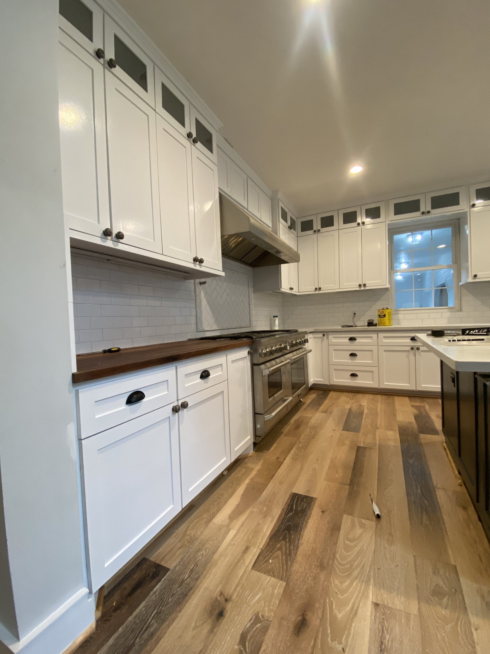 Completed kitchen cabinetry and appliance wall, full project view 9